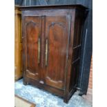 An 18th century provincial French joint oak armoire, the pair of twin panelled doors on iron hinges,