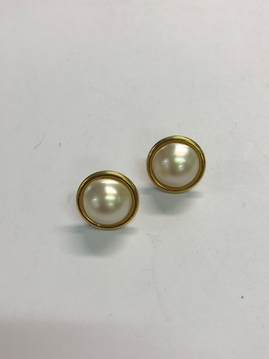 A pair of mabe pearl earrings in yellow metal mounts stamped 750, post fittings for pierced ears,