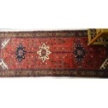 A Persian Hamadan runner, the stylised floral design on red ground, 300 x 125 [14]