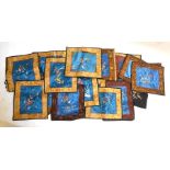 A collection of twenty-five backed and bordered Chinese silk panels embroidered with birds, flowers,
