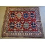 A Caucasian design Afghan carpet, the geometric star motifs on red-brown ground, 2.11 x 2.08 m