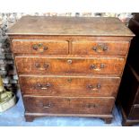 An 18th century oak chest of two short over three long graduated drawers raised on shaped bracket