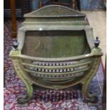 A Georgian style cast iron fire basket with brass urn finials, showing wear and patination but