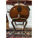 An unusual antique knife sharpener, oak cased, raised on a cast iron stand branded for Harrods