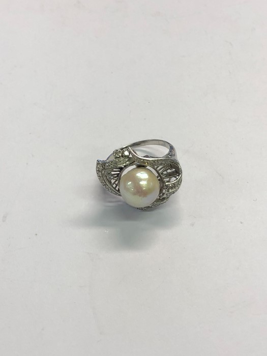 A white metal cluster ring, the central large cultured pearl with closed back and ornate scroll - Image 2 of 2