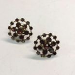 A pair of circular garnet clusters, converted as earrings for pierced ears, 2 cm diam