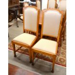 A set of eight Arts and Crafts style light oak dining chairs with pale fawn upholstered high back