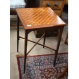 An Edwardian mahogany and parquetry occasional table raised on slender square tapering supports