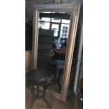 A large silvered framed mirror