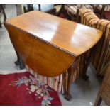 A mahogany drop leaf table on cabriole supports with ball and claw feet