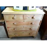 A Victorian pine chest of two short over three long drawers raised on short turned supports