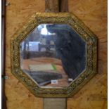 Octagonal brass wall mirror with floral Celtic decoration