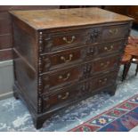 An 18th century oak jointed chest, the four long graduated drawers with applied geometric mouldings,