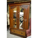 Edwardian carved mahogany wardrobe with mirrored doors over a base fitted with a single drawer