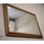A large pine framed bevelled edge wall mirror