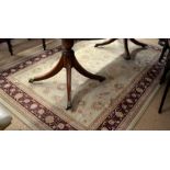 A 'Mastercraft Noble Art' Persian style rug with scrolling floral design on camel ground and