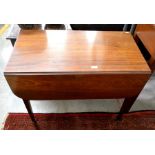 A 19th century mahogany pembroke table with end drawer and opposing dummy drawer raised on taperoing