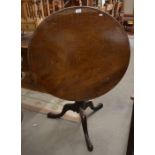 A George III mahogany tilt-top table, the circular tilt-top on revolving birdcage and turned