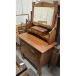 Arts and Crafts oak dressing table, the raised back with rectangular mirror and small fitted