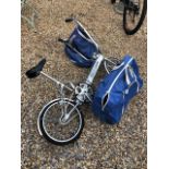 A pair of 1970's vintage Bickerton portable folding bikes, aluminium framed c/with carry holdalls (