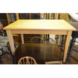 A modern beech rectangular kitchen dining table on tapering square supports