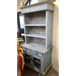 A French distress blue painted dresser with two shelves over a base with drawers and glazed doors