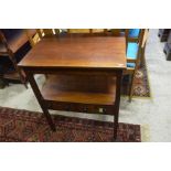 A 19th century mahogany two-tier side table with two drawers, raised on square supports