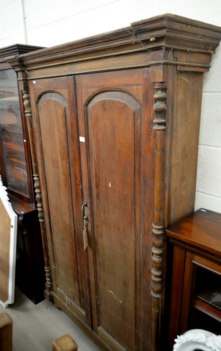 A hardwood shallow hall cupboard with full length panelled doors enclosing shelved interior