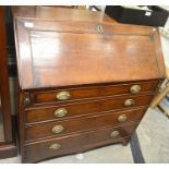 A Georgian oak fall front bureau with fitted interior over four graduating drawers raised on bracket