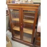 A 19th century mahogany bookcase with a pair of glazed doors enclosing two shelves, raised on a