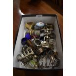 A box of mixed items to include four small electroplated toast racks, novelty shoe pin cushion,