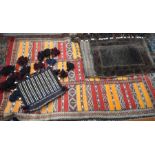 An early 20th century kelim rug with bands of repeating geometric motif to/w Balouchi carpet bags