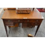 an edwardian mahogany dressing table with four frieze with brass handles raised on slender