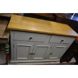 Cream painted oak top dresser base with two drawers over panelled cupboard doors raised on bracket