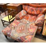 A geometric kelim covered armchair to/w a kelim covered footstool on turned mahogany supports (A/F)