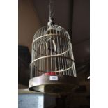 A brass hanging bird cage