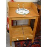 A stained pint two tier wash stand  with fitted brass hot and cold faucets and a polychrome