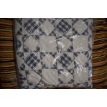 A machined blue/white gingham patchwork quilt