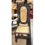 Continental heavily carved oak hall chair, cane worked back and seat and barley twist supports (A/