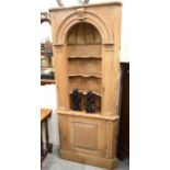 A carved pine 'Nieche' 18th century style corner cabinet with open shelves over a panelled