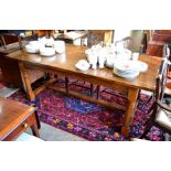 A good quality oak refectory dining table, three plank rectangular top with cleated ends raised on