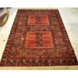 A Belgium machine made Turkoman style rug with geometric design on red ground 140 x 200 cm
