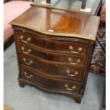 A Georgian style crossbanded mahogany bachelor's chest, the serpentine front with fitted slide