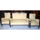 Edwardian carved mahogany salon suite comprising a two seater settee and a pair of matching arm