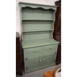A green painted pine dresser, the plate rack with two shelves over drawers and cupboard doors