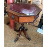 An octagonal drum table with red leather top