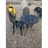 A Victorian style alloy garden table and two chairs
