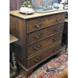 An 18th century oak chest of two short over three long graduated drawers with brass fittings, raised