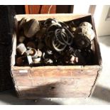 An old wooden champagne crate containing a very large quantity of assorted antique and later brass