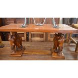 A rectangular hardwood coffee table on twin elephant carved supports